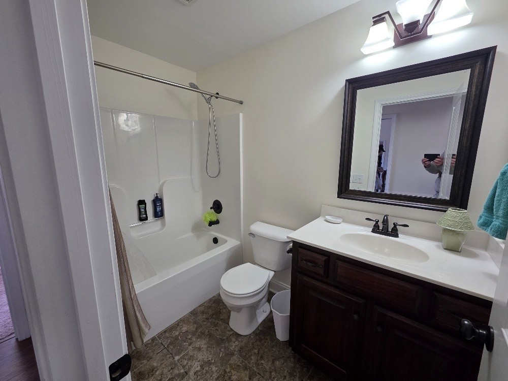 100 Ladybug Lane Bethpage, TN 37022 - Photo 24 of 56 a bathroom with a sink a toilet a mirror a vanity and bathtub