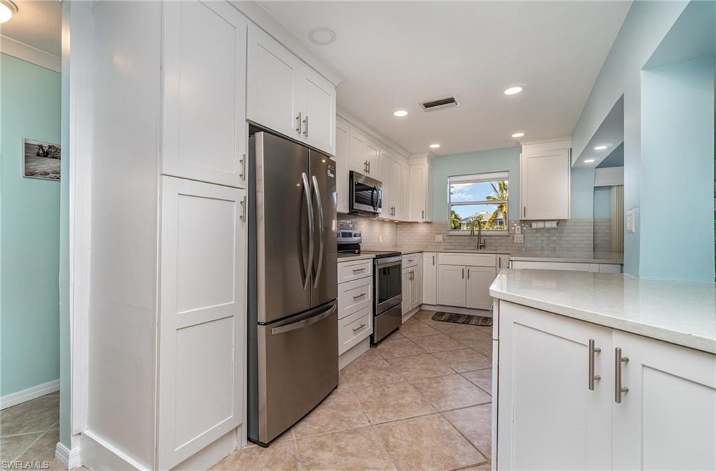 4826 Gary Road Bonita Springs, FL 34134 - Photo 9 of 24 Kitchen opens into Living Room & Dining Areas!