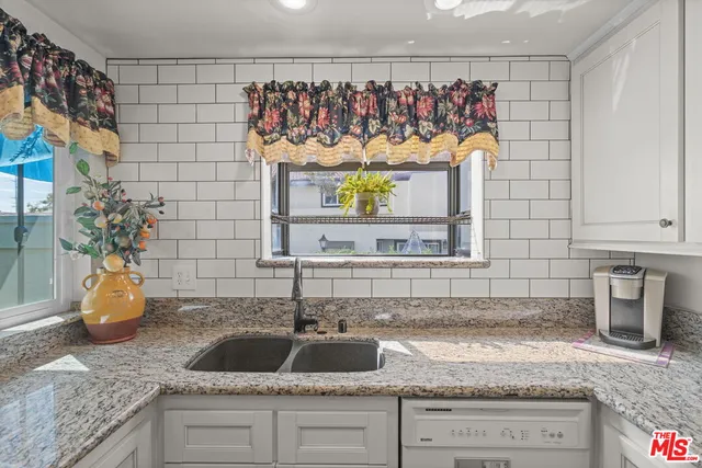 a kitchen with a sink and a wooden cabinets