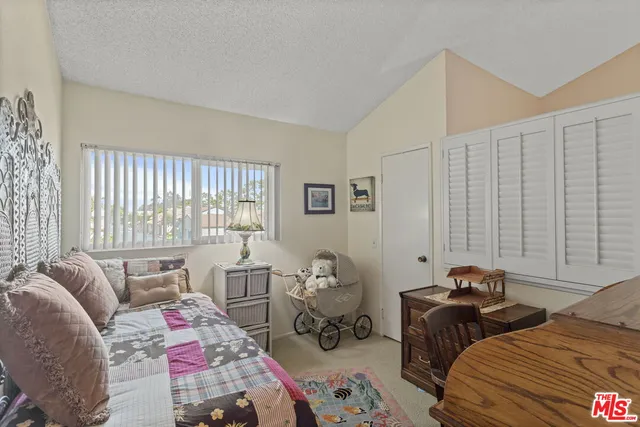 a bedroom with bed and a window