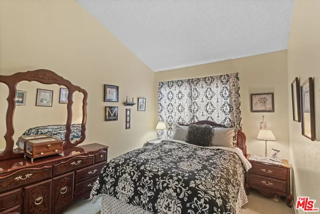 a bedroom with a bed and a television