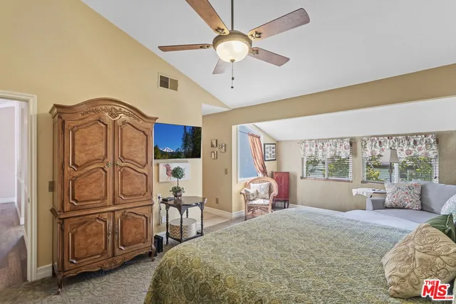 a spacious bedroom with a bed dresser and a window