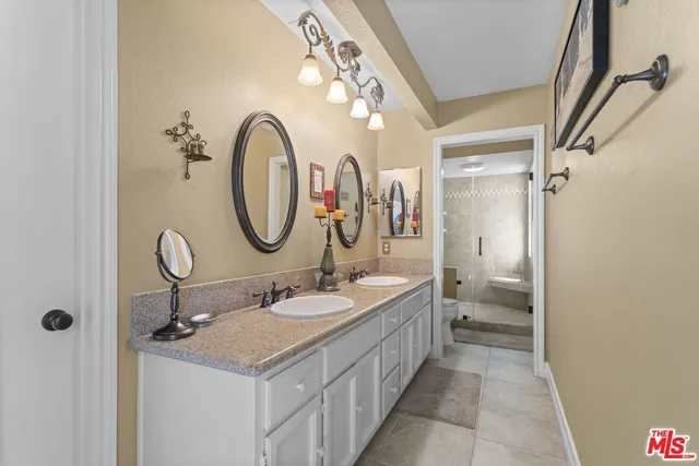 a bathroom with a double vanity sink and a mirror