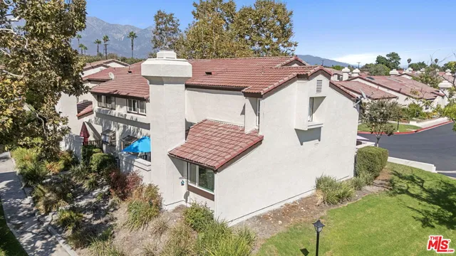 a aerial view of a house with a yard and potted plants