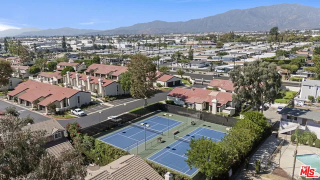 an aerial view of residential houses with outdoor space