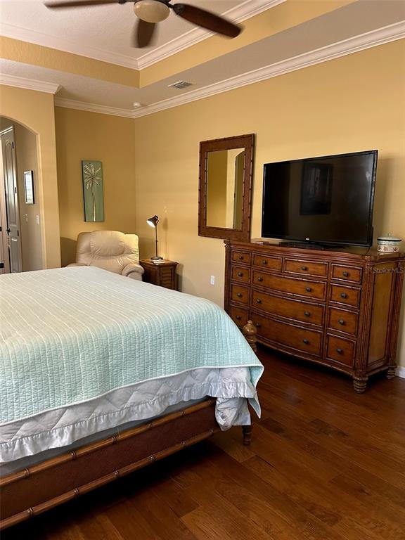 8979 Southwest 86th Loop Ocala, FL 34481 - Photo 12 of 28 a spacious bedroom with a bed and a flat screen tv