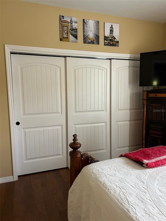 8979 Southwest 86th Loop Ocala, FL 34481 - Photo 16 of 28 a bedroom with a bed and a flat screen tv