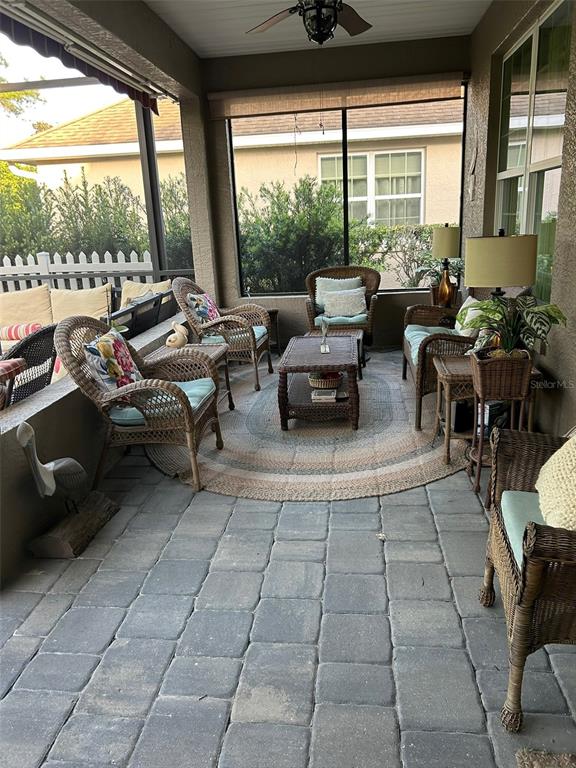 8979 Southwest 86th Loop Ocala, FL 34481 - Photo 28 of 28 a living room with patio furniture and floor to ceiling windows