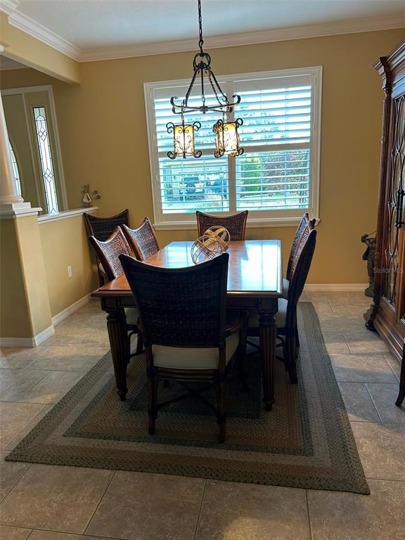 8979 Southwest 86th Loop Ocala, FL 34481 - Photo 10 of 28 a view of a dining room with furniture window and wooden floor
