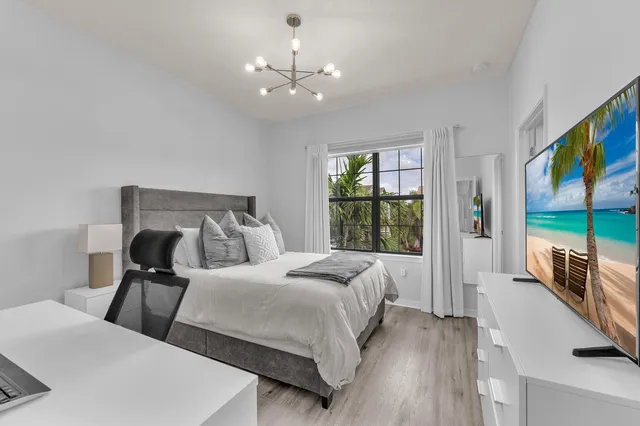 a bedroom with bed and window