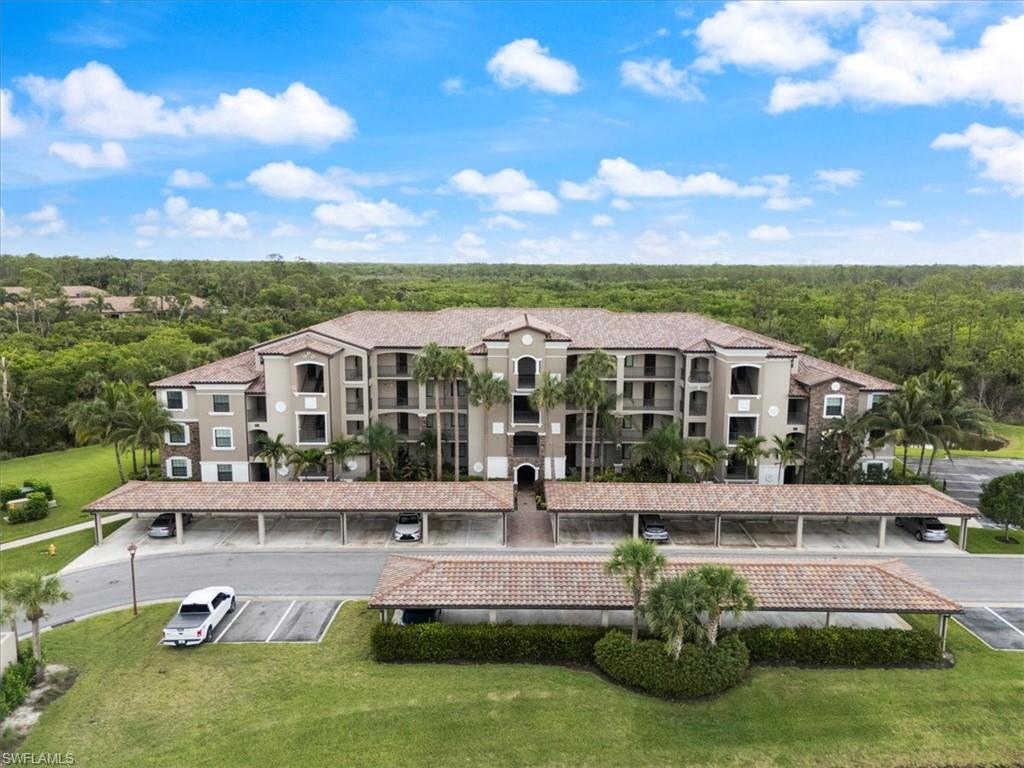 9830 Giaveno Circle, Unit 1622 Naples, FL 34113 - Photo 1 of 43 a front view of a house with garden and swimming pool