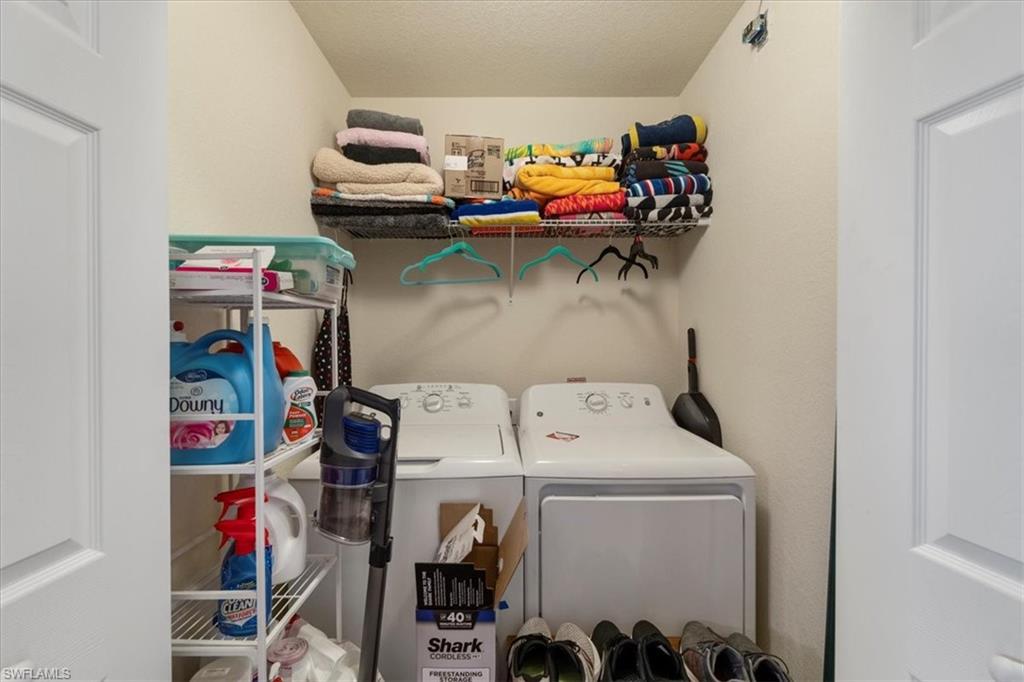 9830 Giaveno Circle, Unit 1622 Naples, FL 34113 - Photo 21 of 43 a utility room with dryer and washer