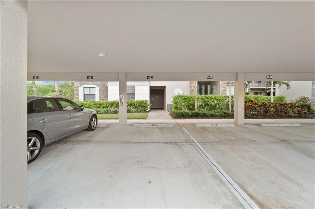 9830 Giaveno Circle, Unit 1622 Naples, FL 34113 - Photo 22 of 43 a view of building with cars parked