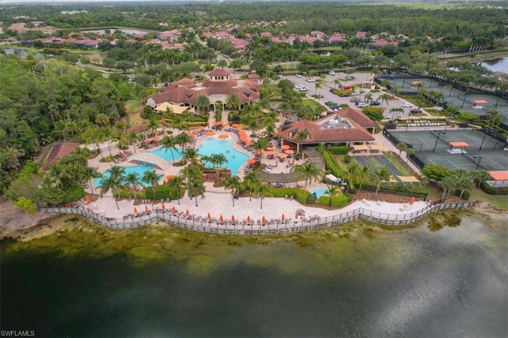 9830 Giaveno Circle, Unit 1622 Naples, FL 34113 - Photo 28 of 43 an aerial view of residential houses with outdoor space and trees