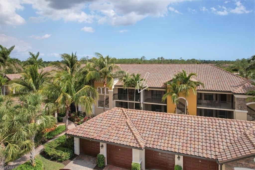 9830 Giaveno Circle, Unit 1622 Naples, FL 34113 - Photo 30 of 43 a view of a patio with swimming pool and sitting space