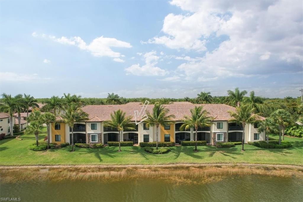 9830 Giaveno Circle, Unit 1622 Naples, FL 34113 - Photo 31 of 43 a front view of a house with a yard