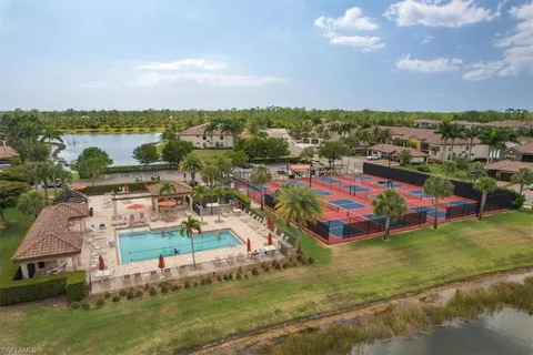 an aerial view of residential houses with outdoor space and swimming pool