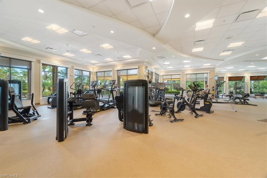 9830 Giaveno Circle, Unit 1622 Naples, FL 34113 - Photo 38 of 43 a view of a room with gym equipment and a large window