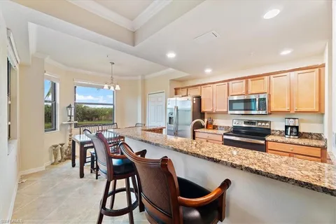 a large kitchen with a table and chairs