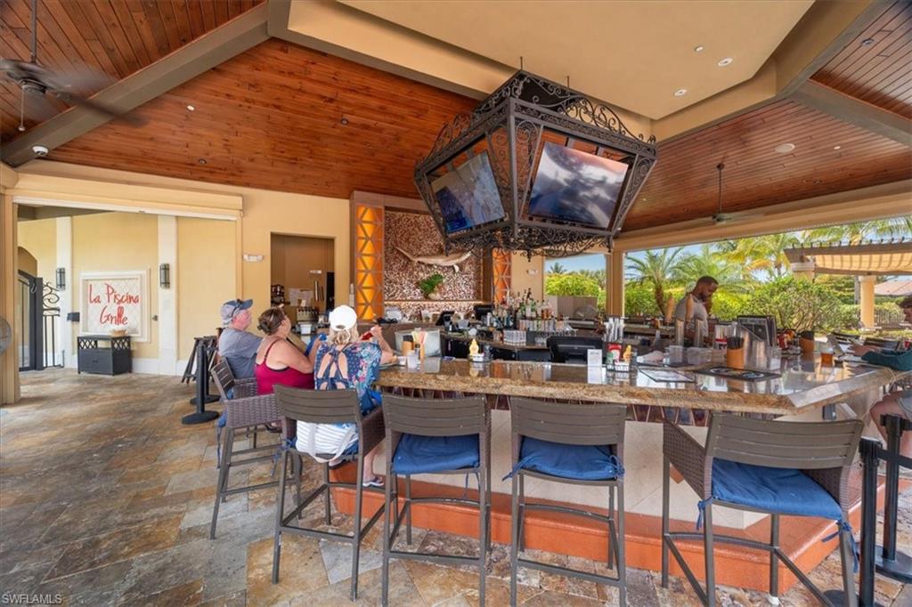 9830 Giaveno Circle, Unit 1622 Naples, FL 34113 - Photo 41 of 43 a view of a dining room with tables and chairs