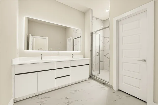 a bathroom with a shower sink and mirror