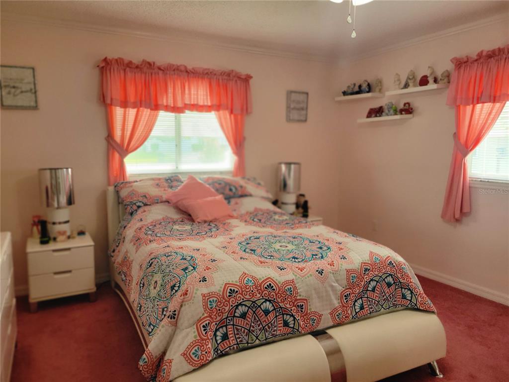 10967 Southwest 65th Avenue Ocala, FL 34476 - Photo 8 of 16 a bedroom with a bed and a window