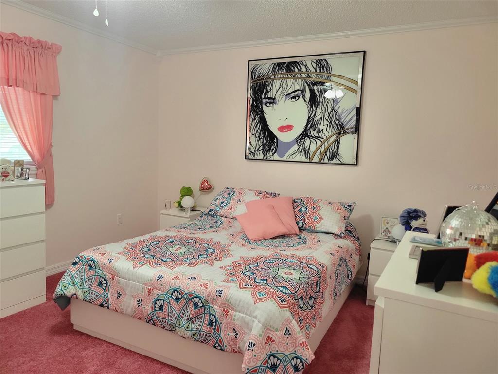 10967 Southwest 65th Avenue Ocala, FL 34476 - Photo 9 of 16 a bedroom with a bed and a cabinet