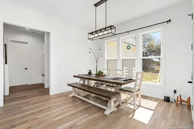 a view of hall way with furniture and wooden floor