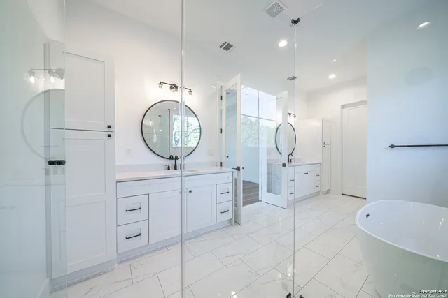 a spacious bathroom with a mirror a sink and a mirror