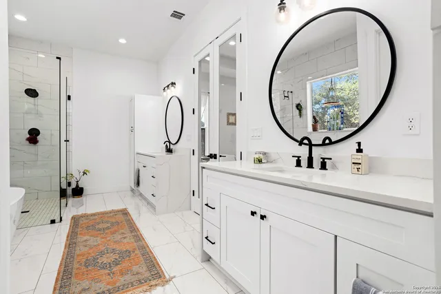 a bathroom with a tub sink and mirror