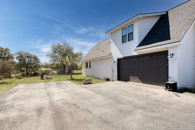 a view of a house with a yard and garage