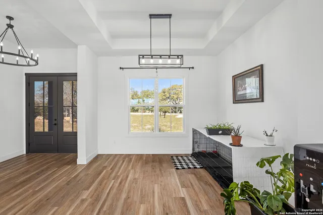 a very nice looking room with wooden floor and a window