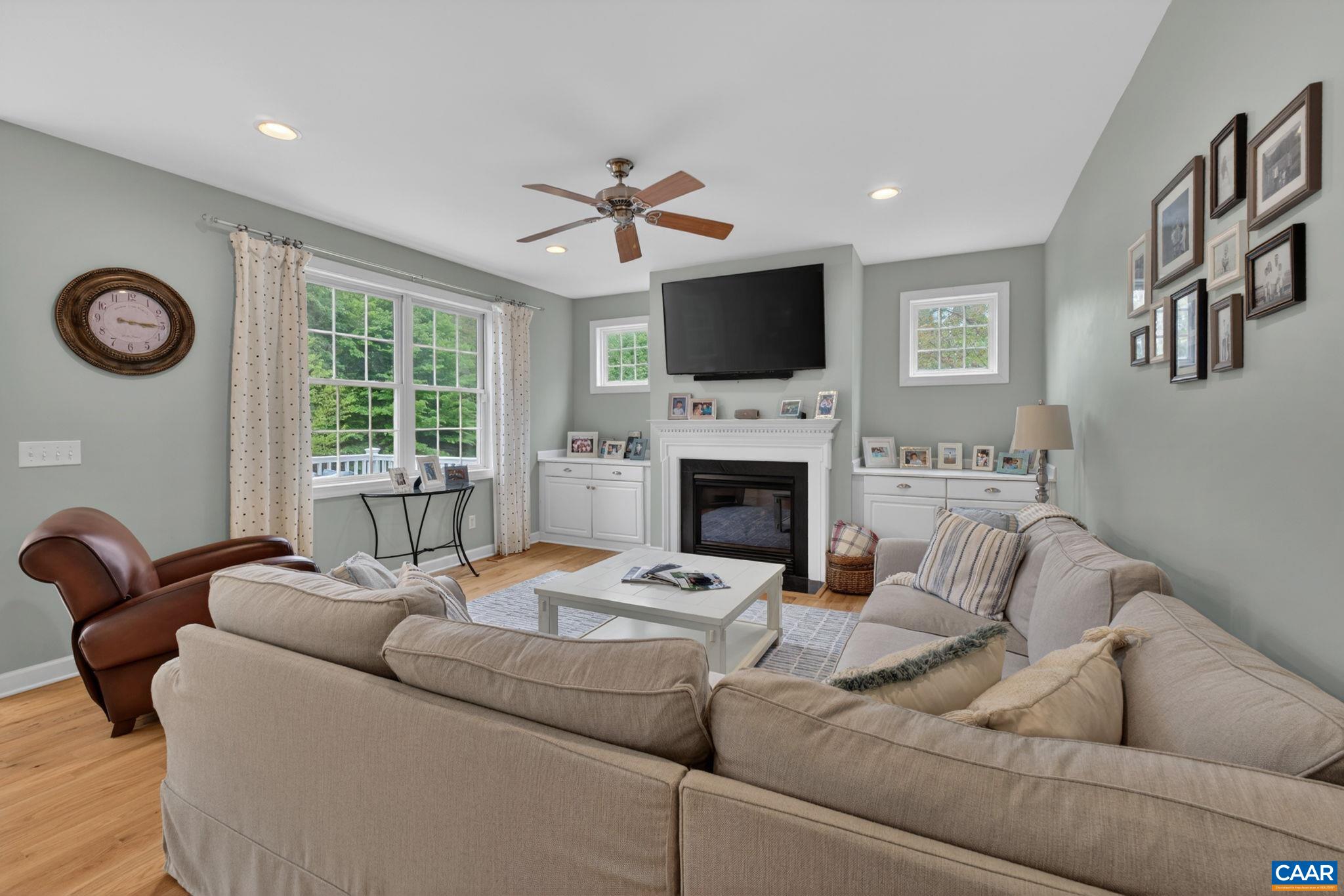 511 Taylor Ridge Way Palmyra, VA 22963 - Photo 12 of 57 a living room with furniture a fireplace and a flat screen tv