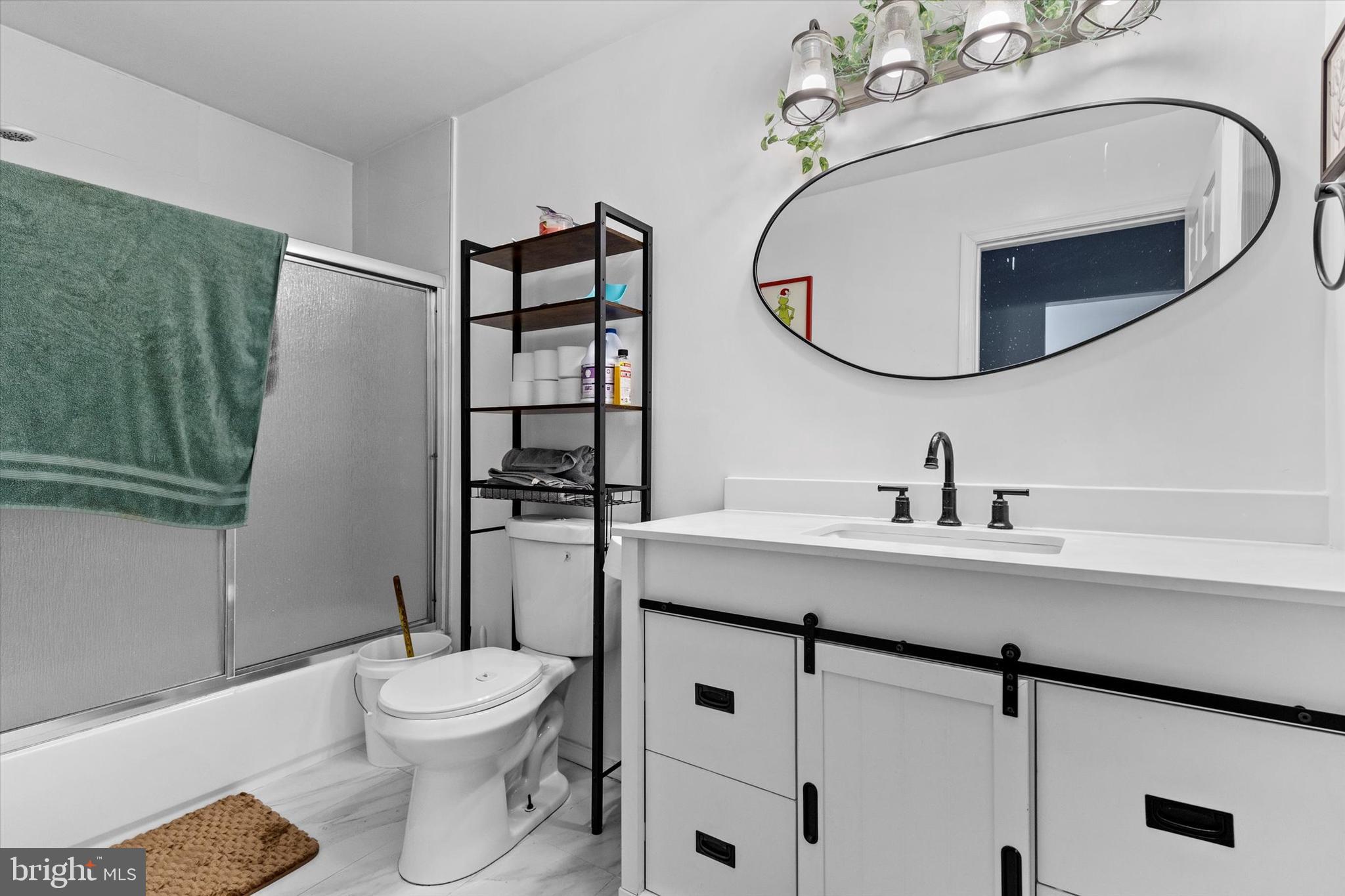 826 South Beaver Street York, PA 17403 - Photo 11 of 26 a bathroom with a toilet a sink and mirror