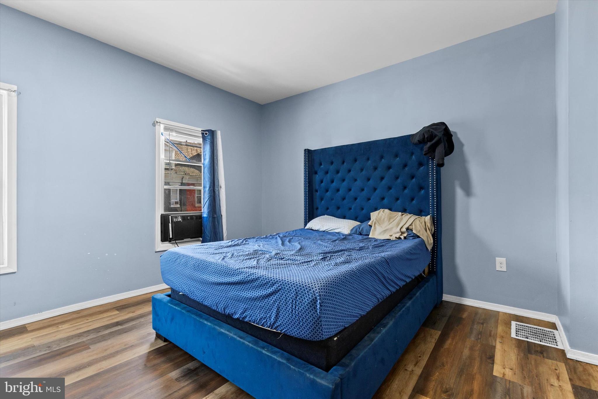 826 South Beaver Street York, PA 17403 - Photo 12 of 26 a bed sitting in a bedroom next to a window and wooden floor