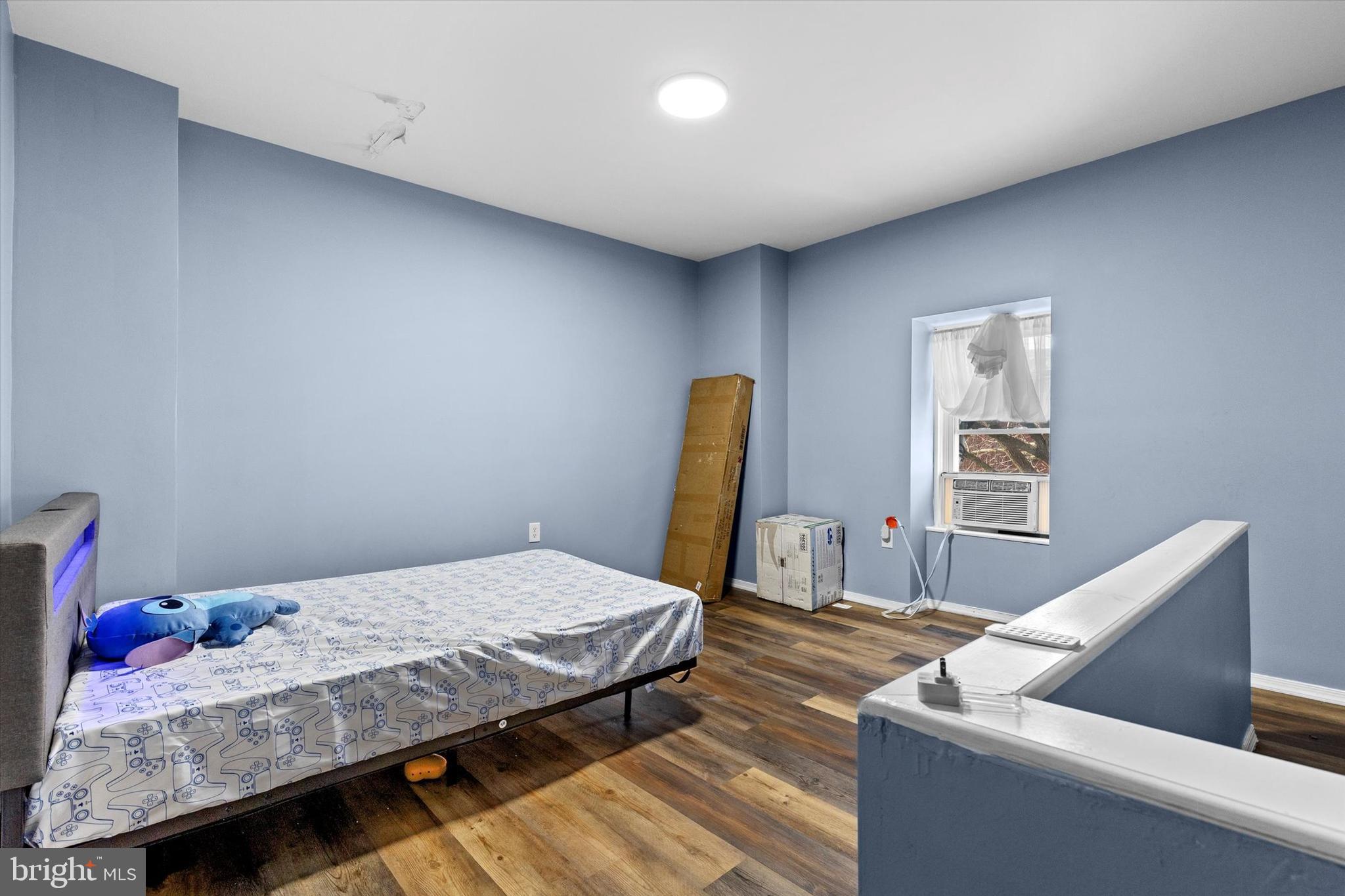 826 South Beaver Street York, PA 17403 - Photo 15 of 26 a bedroom with a bed and wooden floor