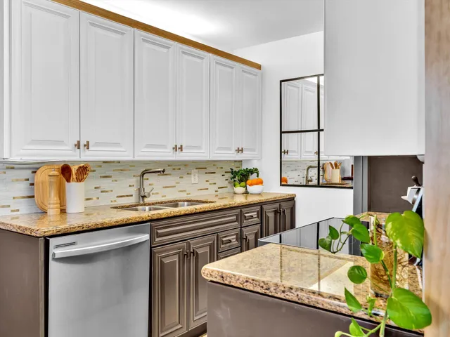 a kitchen with a refrigerator table and chairs
