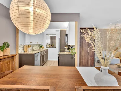 a view of a dining room with furniture and a potted plant