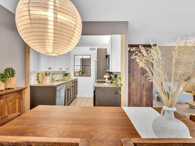 a view of a dining room with furniture and a potted plant