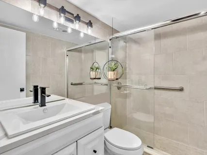 a bathroom with a glass shower door