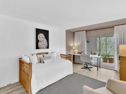 a bedroom with a bed and glass windows