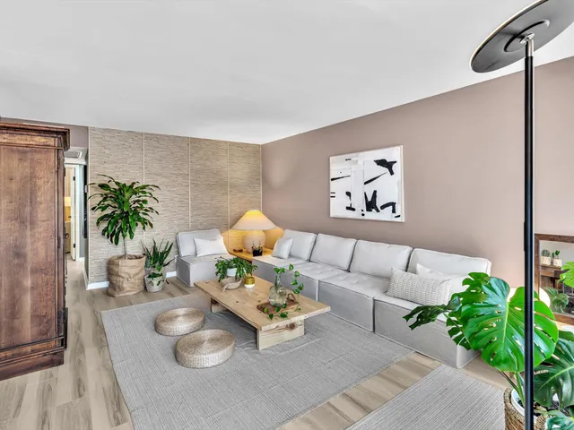 a living room with furniture and a potted plant