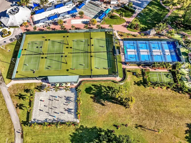 an aerial view of a house with a garden and outdoor seating