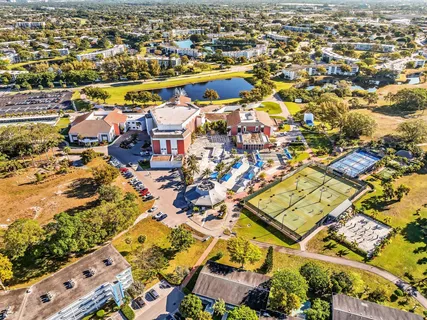 a living room with stainless steel appliances kitchen island lots of furniture and clutter