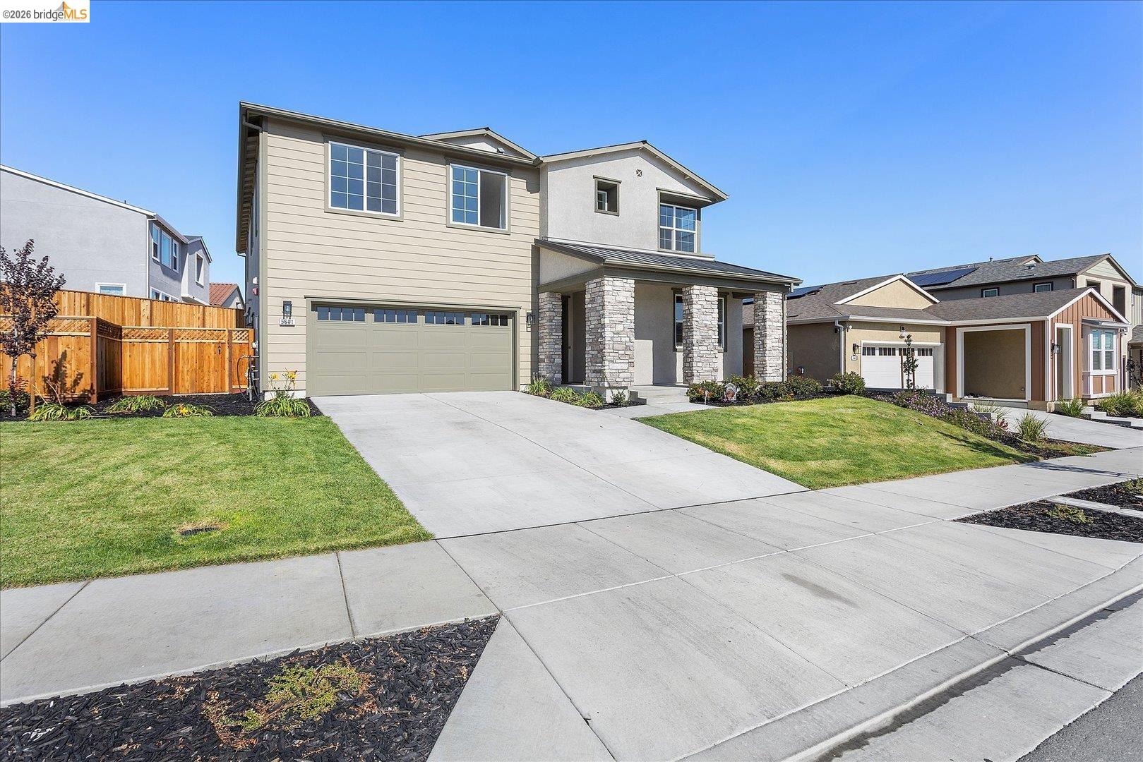 5601 Ridgepoint Way Antioch, CA 94531 - Photo 4 of 59 Two-story residence featuring a neutral-toned siding exterior, stone facade accents, an attached garage, and a concrete driveway