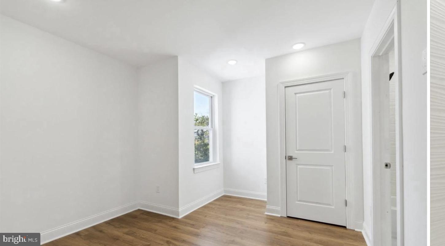673 North Preston Street, Unit 4 Philadelphia, PA 19104 - Photo 8 of 9 an empty room with wooden floor and windows