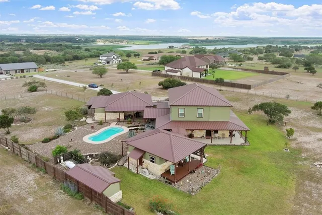 an aerial view of a house with garden space and ocean view
