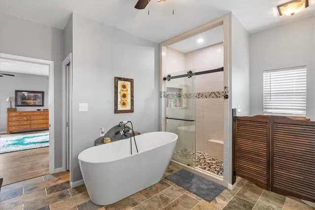a bathroom with a bathtub and shower