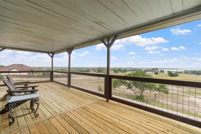 a view of a balcony with wooden floor and outdoor space