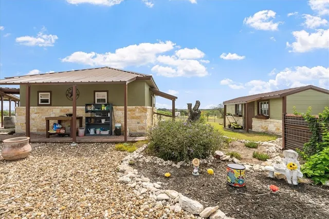 a view of a house with backyard porch and sitting area